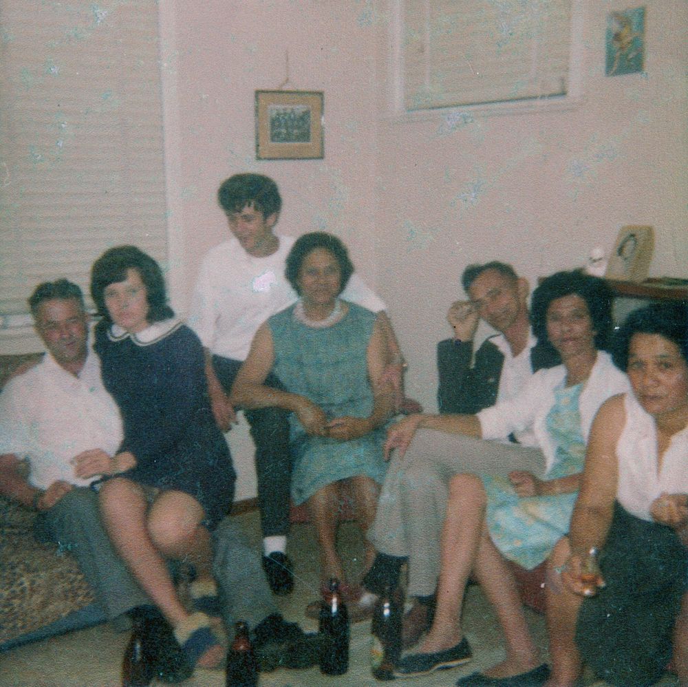 Whānau gathered together indoors, a colour snapshot